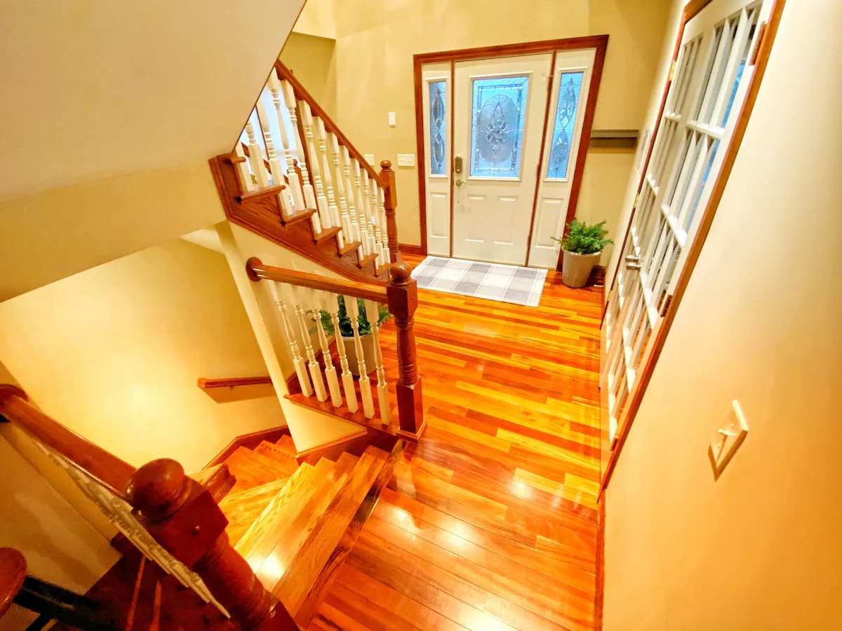 Grand foyer with hardwood floors and staircase