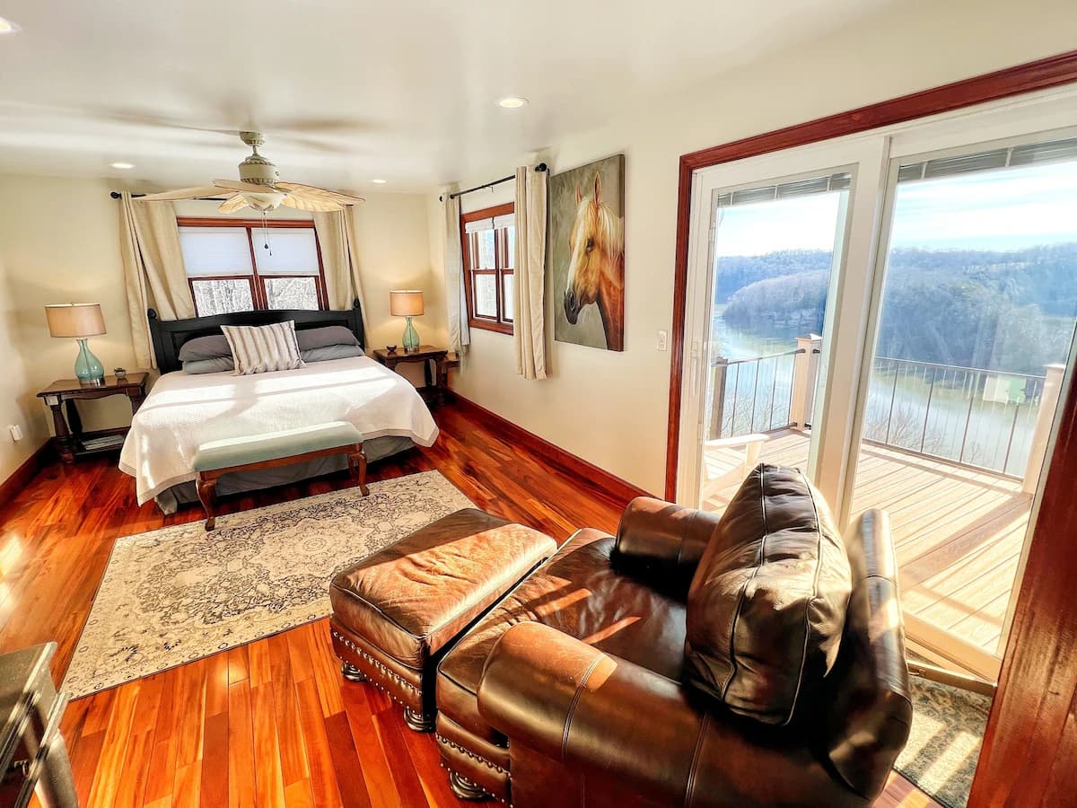 Master bedroom with lake view and deck access